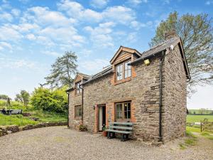 a stone house with a bench in front of it at 2 Bed in Craven Arms oc-95107 in Kerry