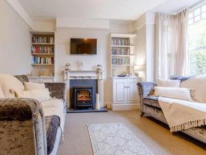 a living room with two couches and a fireplace at 4 Bed in Bideford oc-85720 in Bideford