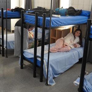 two girls laying on bunk beds in a dorm room at CEAM Tabarca in Tabarca