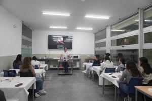 a group of people sitting in a room with a presentation at CEAM Tabarca in Tabarca