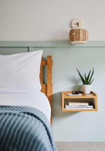 a bedroom with a bed and a nightstand with a plant at Wayfinder Newport in Newport