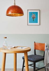 a wooden table and a chair with a lamp at Wayfinder Newport in Newport