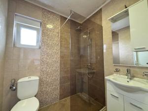 a bathroom with a toilet and a sink and a shower at Vega's in Tivat +45 photos