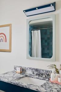 a bathroom with a sink and a mirror at Wayfinder Newport in Newport +192 photos