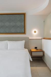 a bedroom with a white bed and a table at Miamar in Manuel Antonio +72 photos