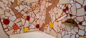 a bathroom with a stained glass shower curtain at Autóctona in Villa Cura Brochero +22 photos