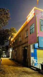 a building with a sign on the side of it at Sri Seshadri Rest House in Avanigadda