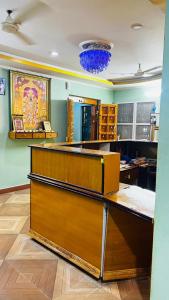 an office with a reception desk with a blue at Sri Seshadri Rest House in Avanigadda