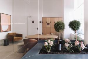 a living room with a table and a chair at Aspasios Sofia Atocha Aparthotel in Madrid
