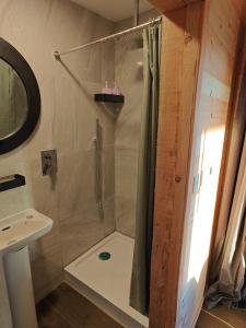 a bathroom with a shower and a sink at The Perch - Romantic Cabin with Sunset Views in Gurteenulla