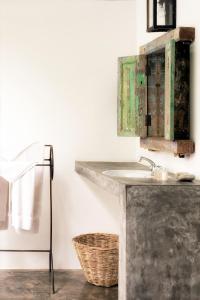 a bathroom with a sink and a mirror at Nisala Arana Bentota, A Private Villa in Bentota