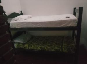 a bedroom with a bunk bed and a small stool at Posada del Baradero in Baradero