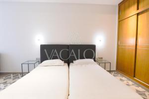 two beds in a room with a sign on the wall at Dassine View - Luxe - Agadir - 4 Px in Agadir
