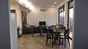 a living room with a dining room table and chairs at Ocean View House, Modern, Elegant with Pool in Coco