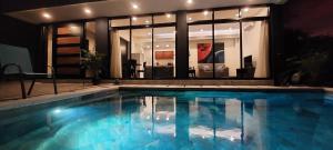 a large swimming pool in front of a house at Ocean View House, Modern, Elegant with Pool in Coco