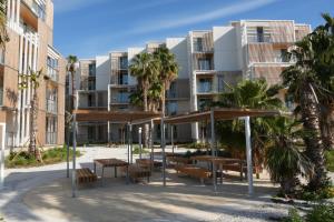 a picnic area in front of a building at Kora Olea in Torremolinos