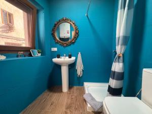 a blue bathroom with a sink and a mirror at Casa Lui Codrut in Alcalà de Xivert +34 photos