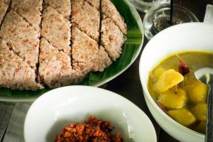 a table with plates of food and a bowl of soup at Nisala Arana Boutique Hotel in Bentota