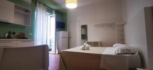 a kitchen with a bed in a room with green walls at CORFÙ 19 Bed & Breakfast in Schiavonea
