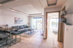 a living room with a couch and a table at Dassine View - Luxe - Agadir - 4 Px in Agadir
