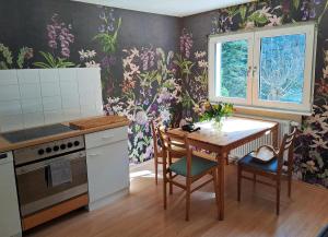a kitchen with a table and a dining room at Casa Karp "Maisonette" in Königstein an der Elbe