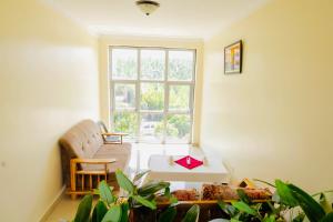 a living room with a couch and a window at Premier motel in Bushenyi +8 photos