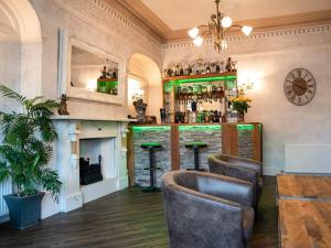 a bar with chairs and a counter in a room at Fox lodge in Blackpool