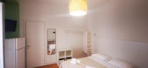 a white room with a bed and a mirror at CORFÙ 19 Bed & Breakfast in Schiavonea