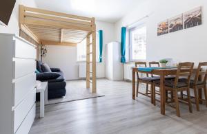 a kitchen and dining room with a table and a couch at Apartmán Denisa in Rokytnice nad Jizerou