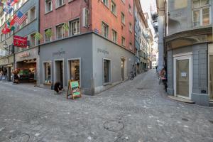 a city street with buildings and a sign on the street at HITrental Eisengasse Apartments in Lucerne