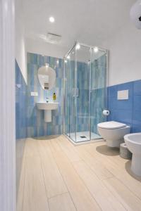 a bathroom with a shower and a toilet and a sink at Noor Palace - PI Collection Hotel in Palermo +47 photos