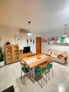 a living room with a wooden table and chairs at Golden Hour House in Termoli