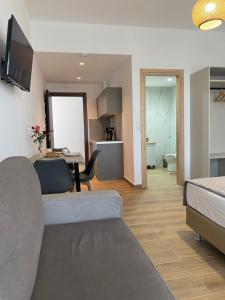 a living room with a bed and a dining room at SunSea Studios close to the beach in Kato Gouves
