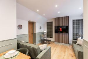 a living room with a couch and a table at New Apartment in Guildford in Guildford