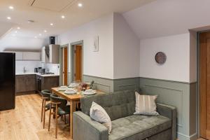 a living room with a couch and a table at New Apartment in Guildford in Guildford