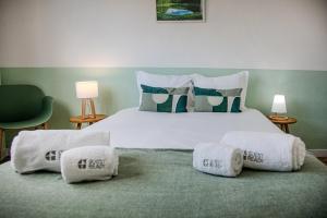 a bedroom with a large white bed with pillows at GuestReady - Beachside house with ocean view in Ponta Delgada