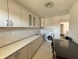 a kitchen with a sink and a washing machine at Vega's in Tivat
