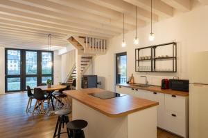 a kitchen and living room with a table and chairs at Valdastico Short Rentals in Maso