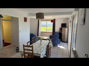 a dining room with a table and blue chairs at Vacation Home in Drôme in Charols