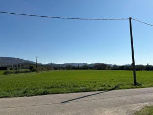 an empty road next to a field with a telephone pole at Vacation Home in Drôme in Charols