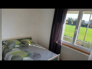 a bedroom with a bed next to a window at Vacation Home in Drôme in Charols