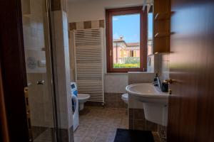 a bathroom with a sink and a toilet and a window at Relais Terre Divino 2 in Ponton