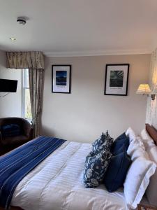 a bedroom with a bed with pillows on it at Springfield House in Grasmere
