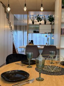 a dining room table with a plate and glasses on it at Weekend apartment 3 in Sigulda +22 photos