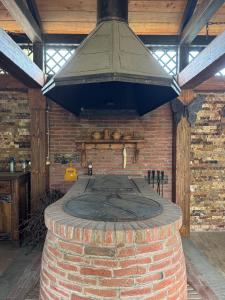 an outdoor brick oven with a hood above it at Aisi Villa in Misakʼtsʼieli