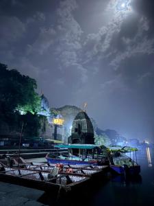 a group of boats docked in a harbor at night at Vrinda's Villa in Maheshwar