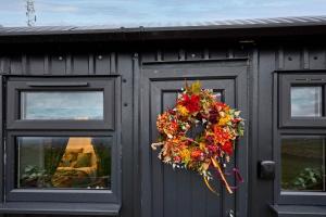 a wreath on the door of a building at Host & Stay - Swallows Nest in Longridge