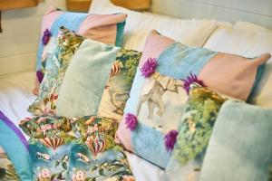 a bed with four pillows on top of it at Host & Stay - Swallows Nest in Longridge +11 photos