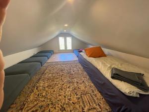 a room with a bed and a couch in a attic at Finca las Estrellas in Relleu +63 photos