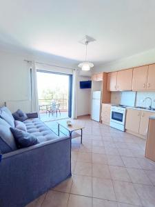 a large living room with a couch and a kitchen at Georgias House in Lefkada